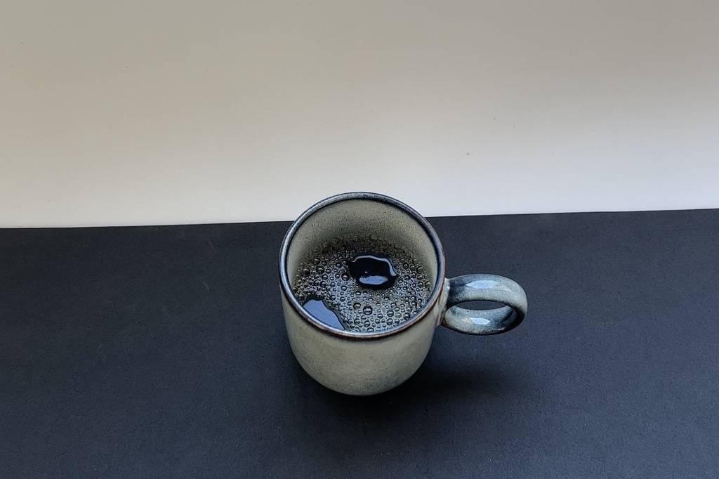 Caneca com líquido preto